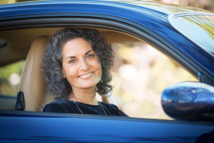 Photo of Anne Malatt in her blue Porsche for article by Dr Anne Malatt on Enriching Life