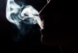 Profile of woman smoking for article by Dr Anne Malatt on Why do doctors smoke?