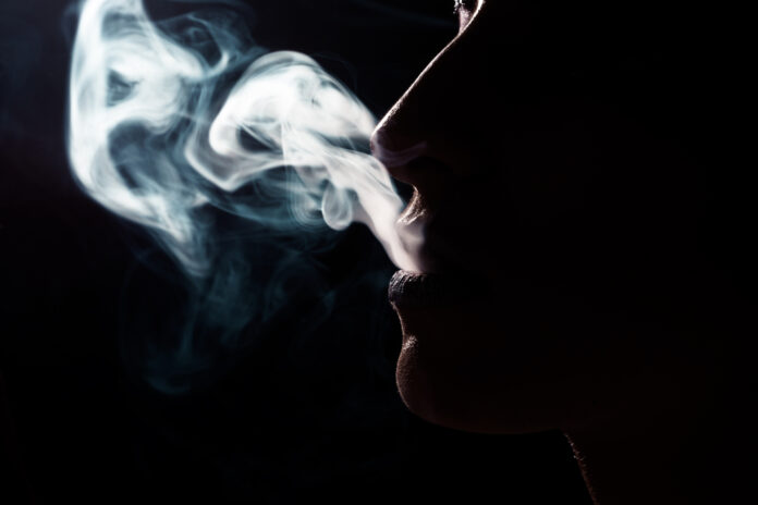 Profile of woman smoking for article by Dr Anne Malatt on Why do doctors smoke?