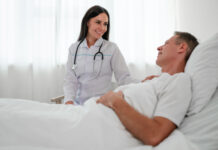 Doctor sitting by patient's bedside