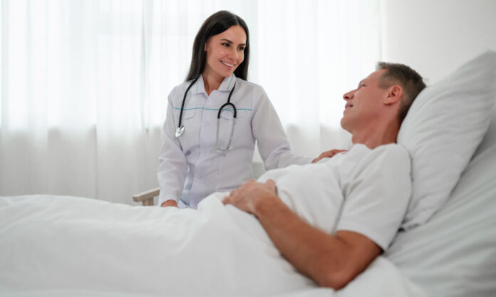 Doctor sitting by patient's bedside